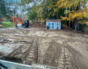 A construction site with a tractor and a shed turned gallery.