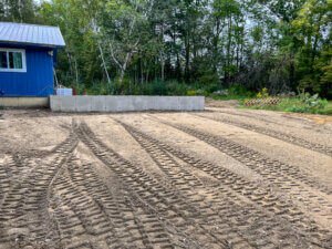 A dirt track in front of a house.